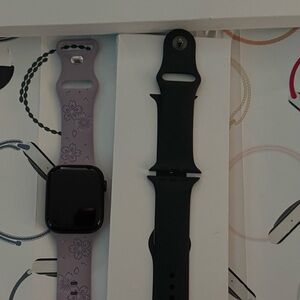 Apple Smartwatch Series 9 GPS+ Cellular 45mm with Black and a lavender bands